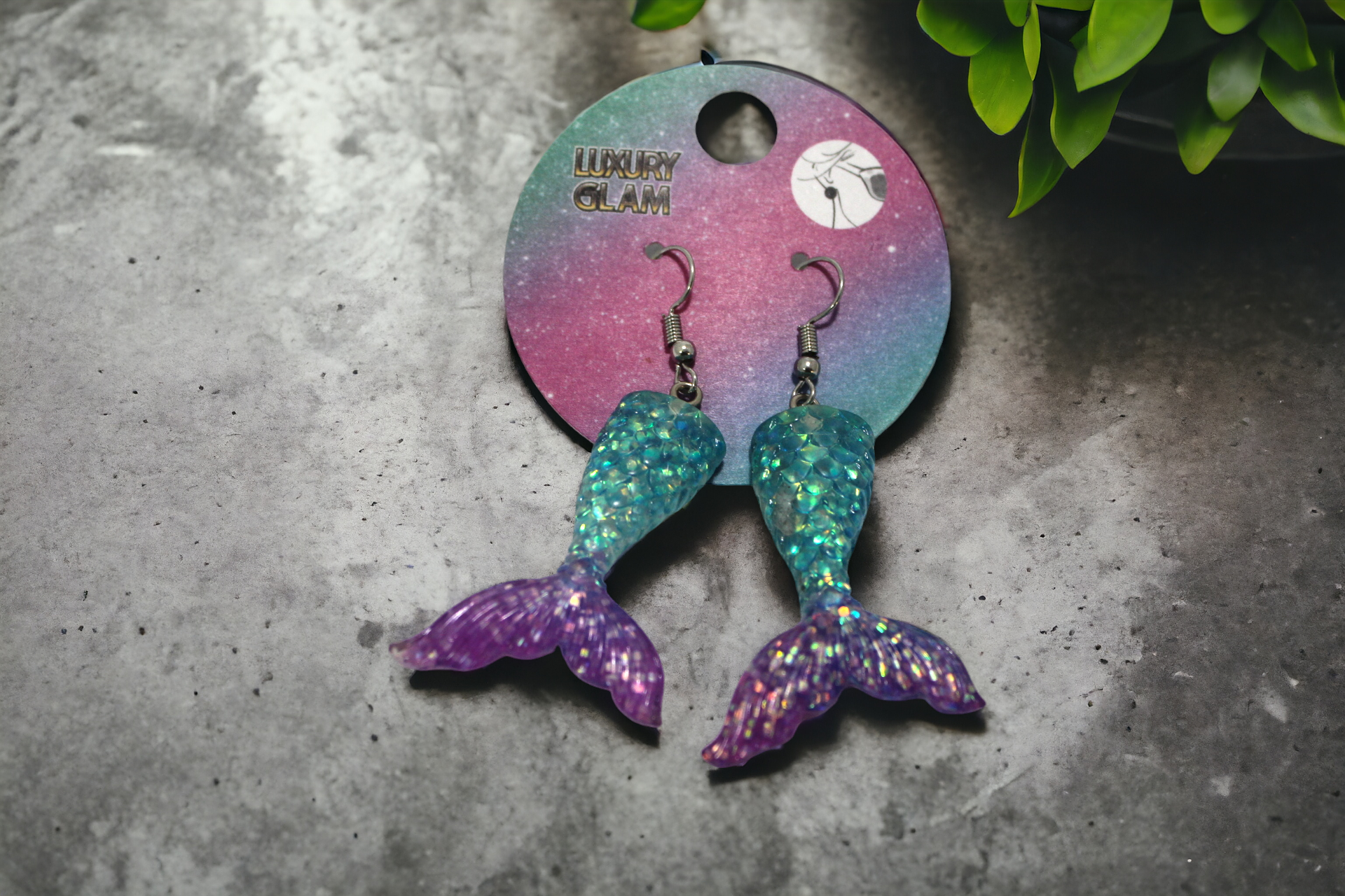 Charm-Schmuck &MEERMAID TAIL Ohrringe in Türkis Lila.
Diese wunderschönen Charm Schmuck Ohrringe in Form einer Flosse dürfen in keinem Schmuckkasten von Meerwesen fehlen.Sie sind ca.4cm lang und die Flossenspitze ca.3cm breit.
Materialien sind
Edelstahlhaken
Flosse Glitzer Harz